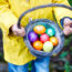 Child Holding Basket Of Easter Eggs